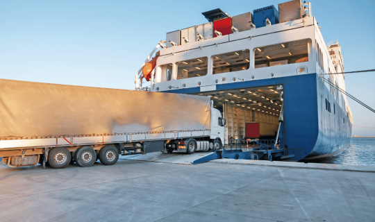 Truck driving onto container ship