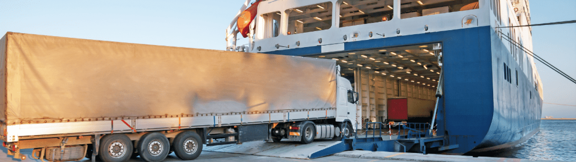 Truck driving onto container ship
