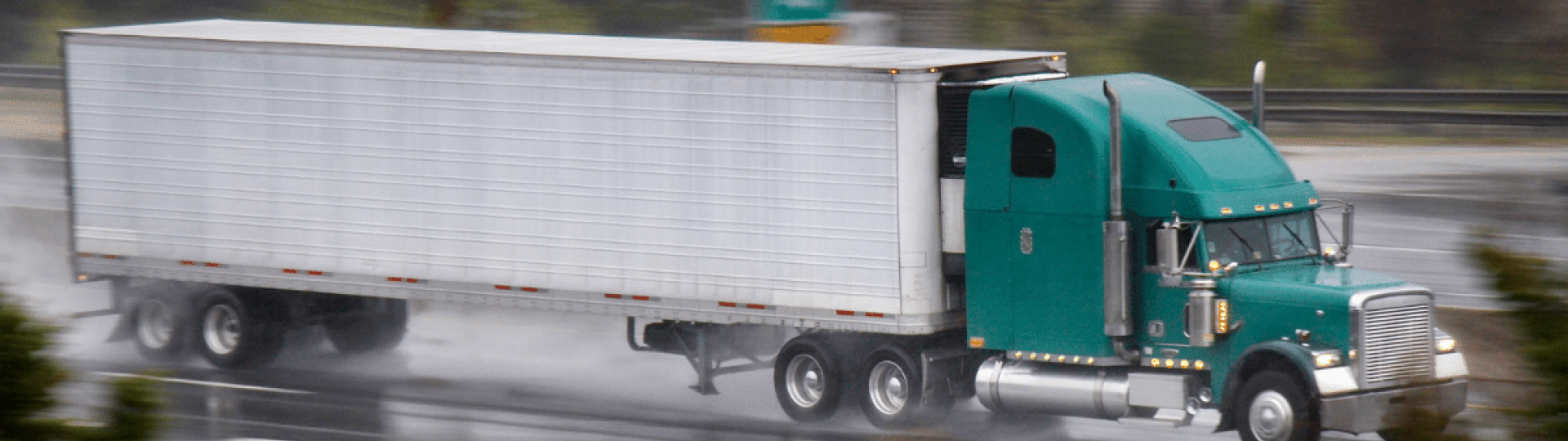 Freight truck travelling on rough and wet road